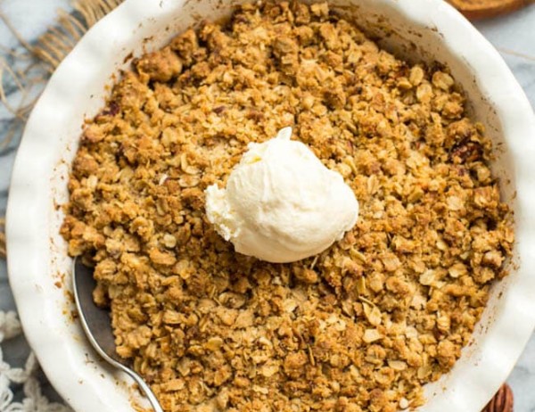 Gluten-Free-Apple-Crisp in a baking dish with ice cream