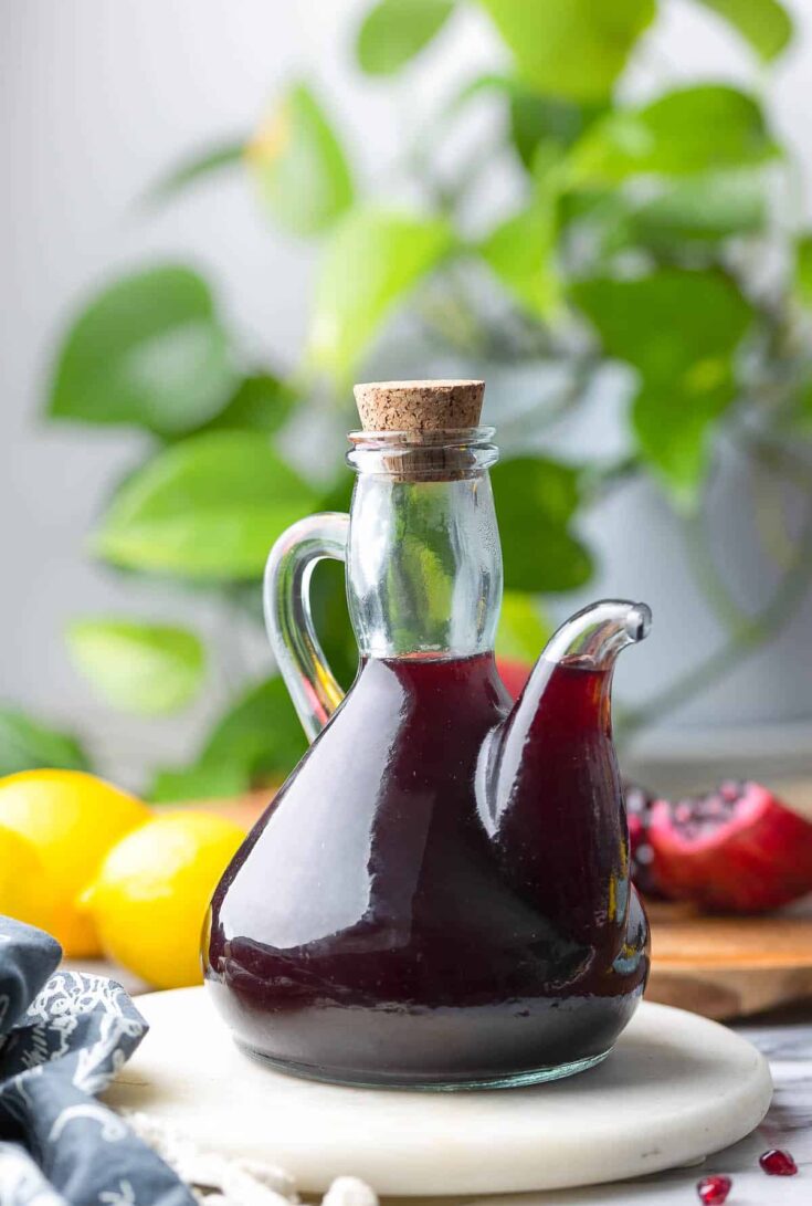 Homemade Grenadine Syrup in a glass bottle with a pouring spout