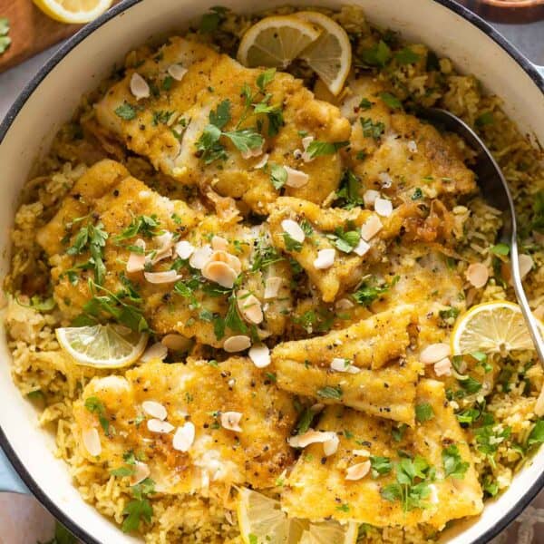 Sayadieh in a big pot - Lebanese fried Fish with Spiced Rice topped with toasted almonds and chopped parsley