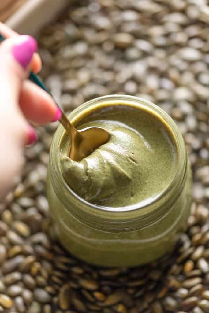Homemade Pumpkin Seed Butter stirred with a little spoon