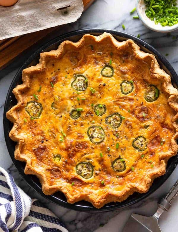 Bacon & Cheddar Jalapeño Quiche with fresh chives on top