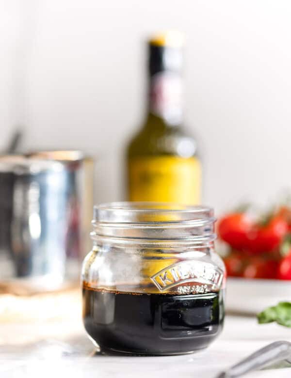 Homemade balsamic glaze in a small storage jar