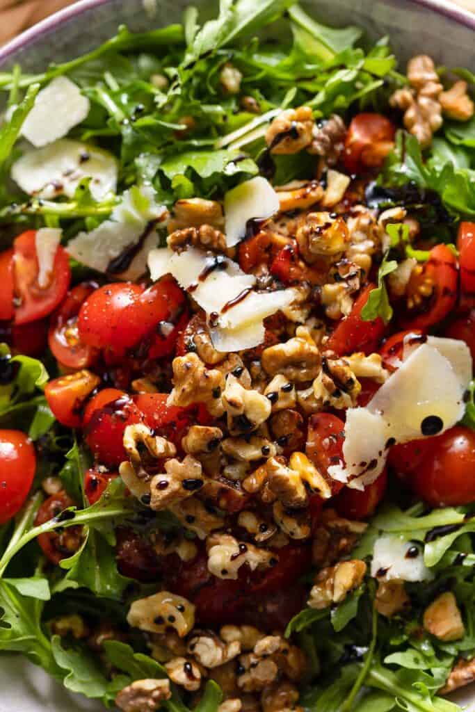 quartered cherry tomatoes, shaved parmesan, walnuts and fresh arugula with a balsamic glaze drizzled over the top