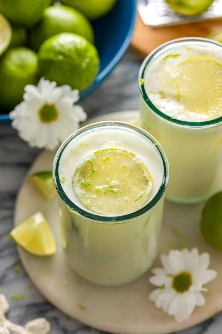 two glasses of Limonada Suíça also known as Brazilian Lemonade garnished with fresh lime slices