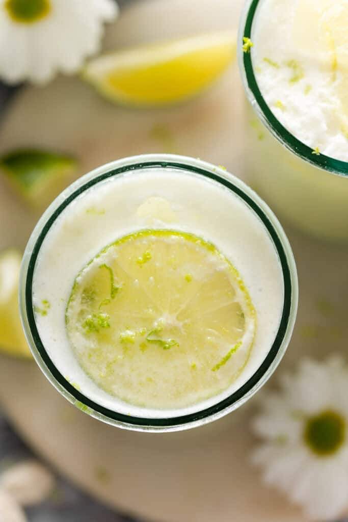 Limonada Suíça also known as Brazilian Lemonade garnished with in a glass with a lime slice and lime zest