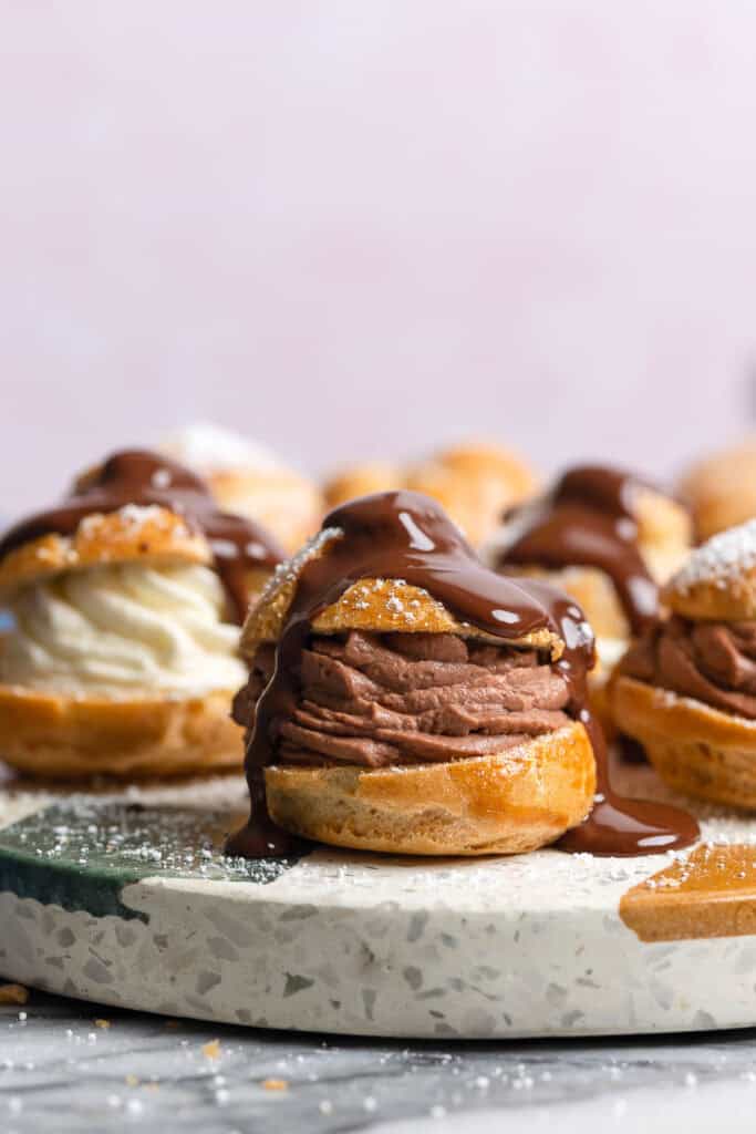 gluten free cream puffs filled with chocolate mascarpone whipped cream and topped with chocolate ganache 