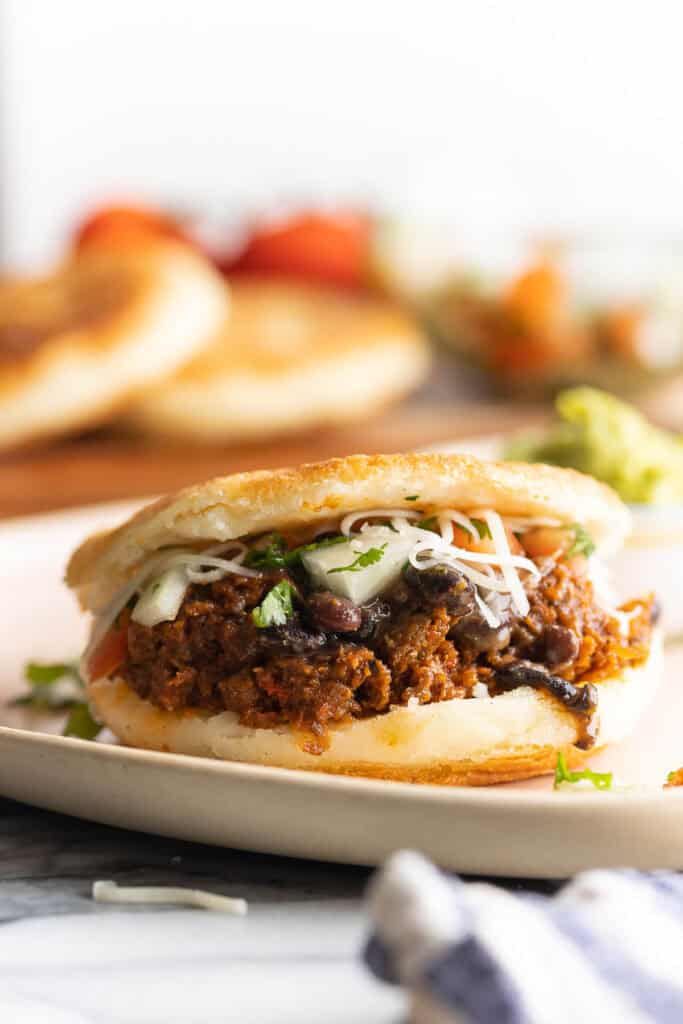 arepas stuffed with carne desmechada, salsa and cheese