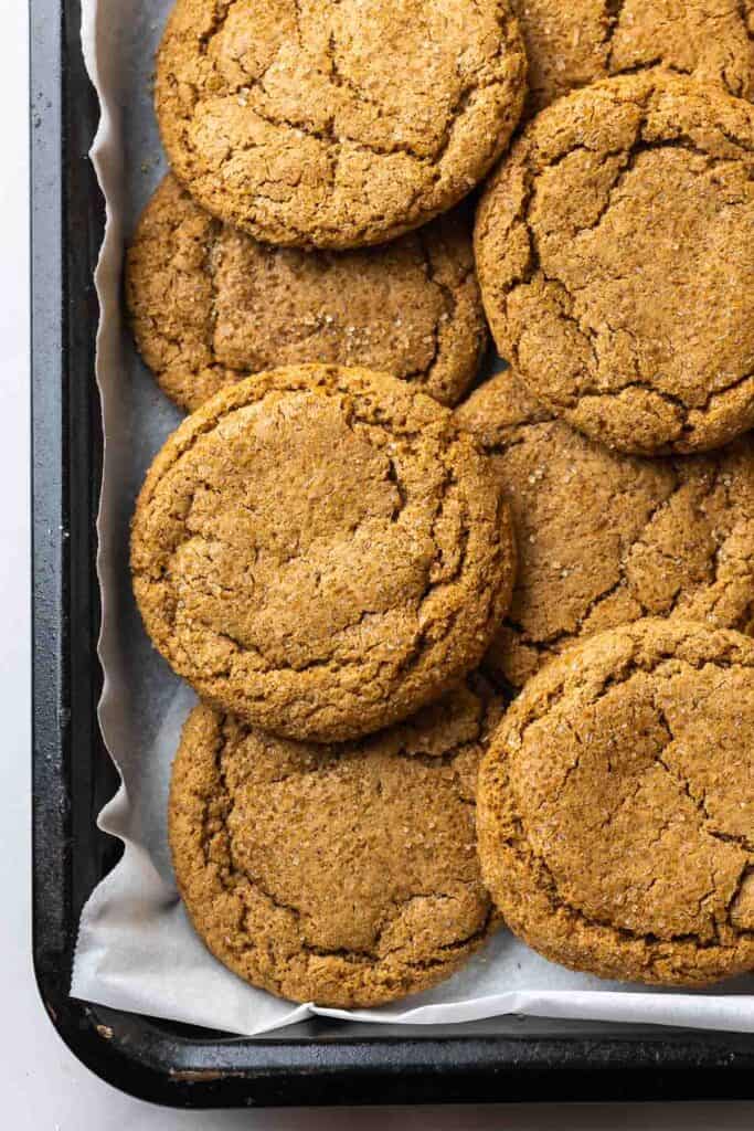 Cardamom Ginger Cookies piled on a baking sheet