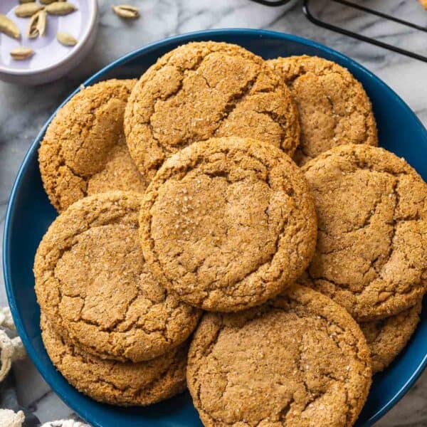 Cardamom Ginger Cookies on a plate with cardamom pods on the side