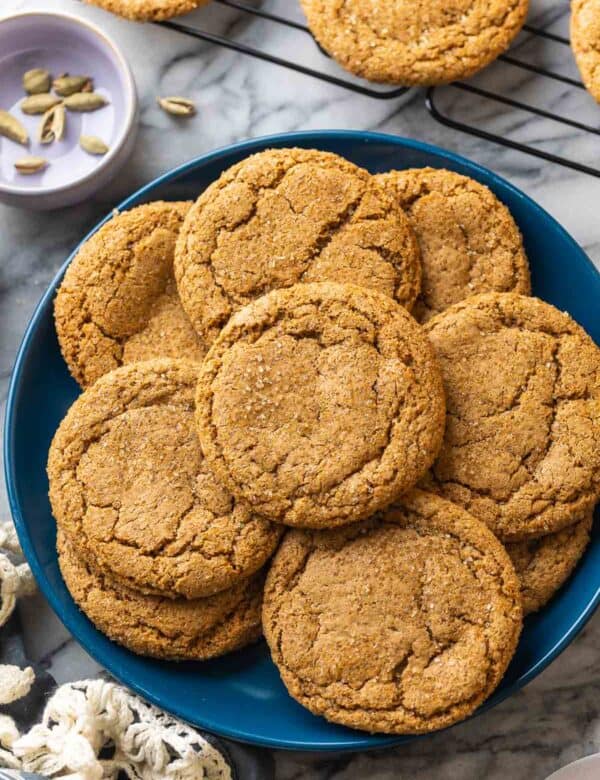 Cardamom Ginger Cookies on a plate with cardamom pods on the side