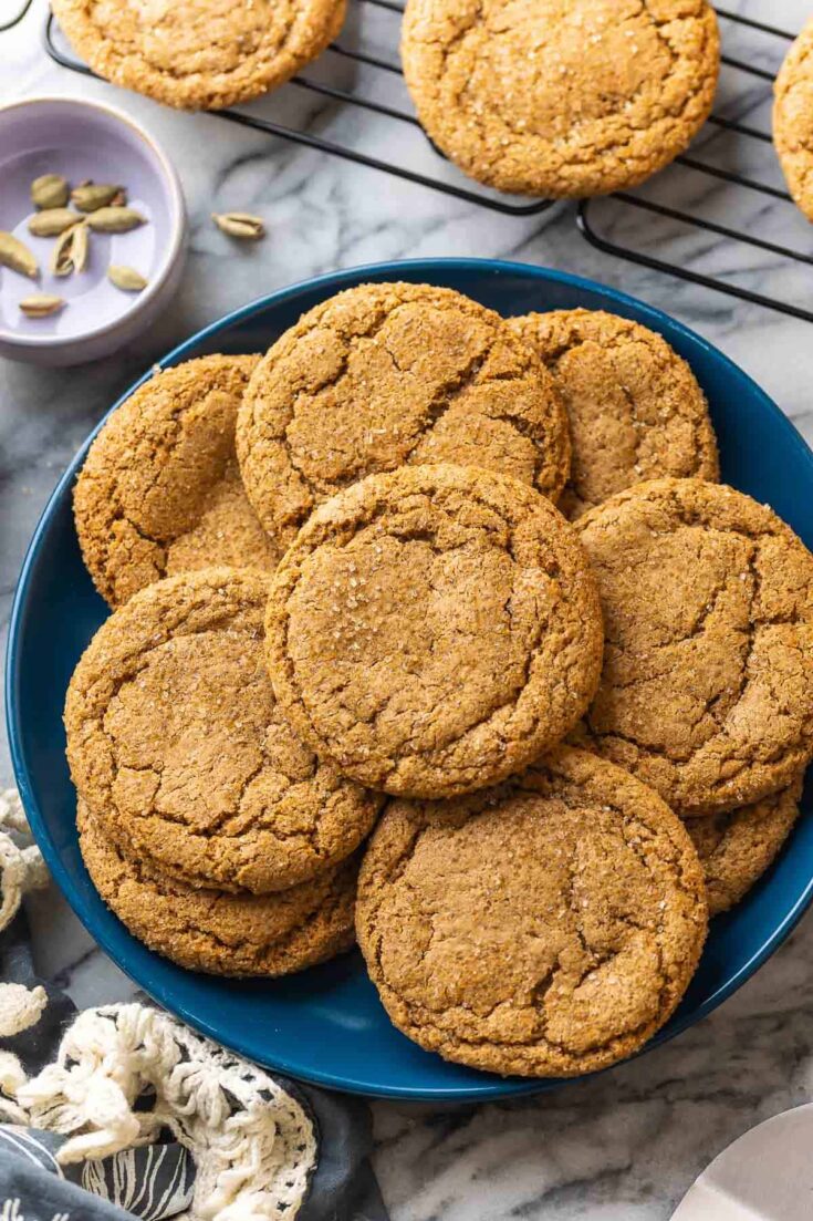 Cardamom Ginger Cookies on a plate with cardamom pods on the side