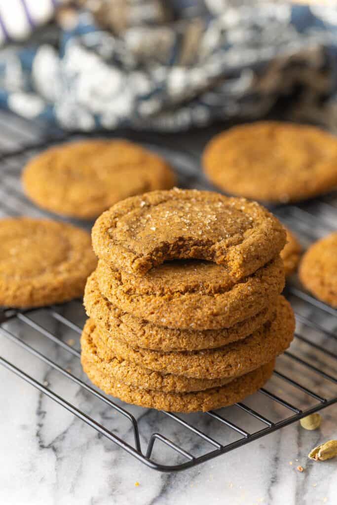 Cardamom Ginger Cookies stacked on a wire cooling rack