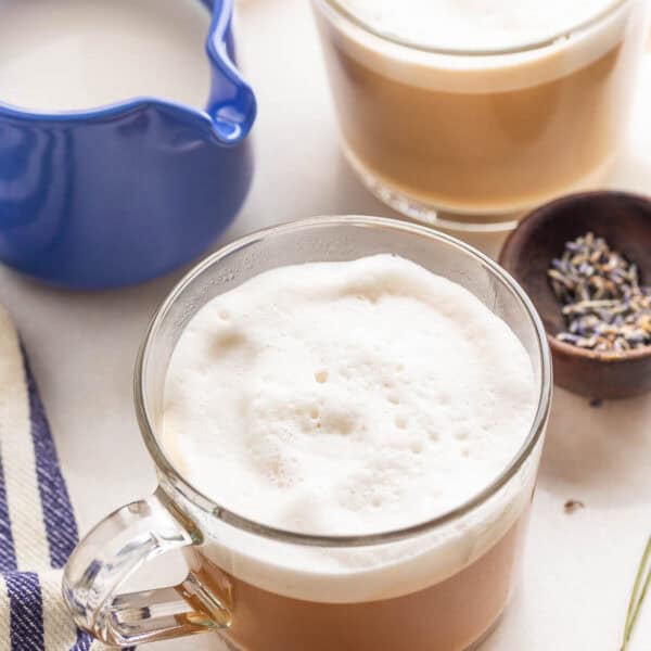 a couple mugs of homemade London fog with milk and lavender on the side