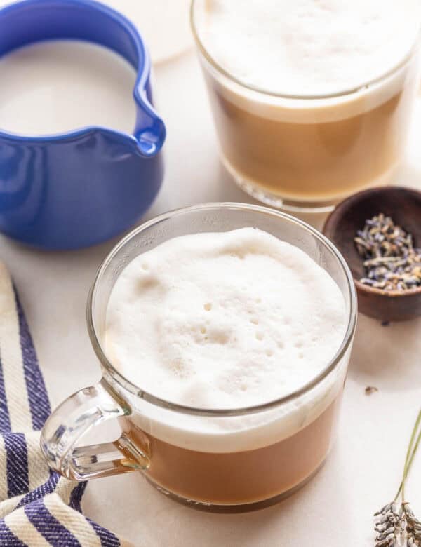 a couple mugs of homemade London fog with milk and lavender on the side