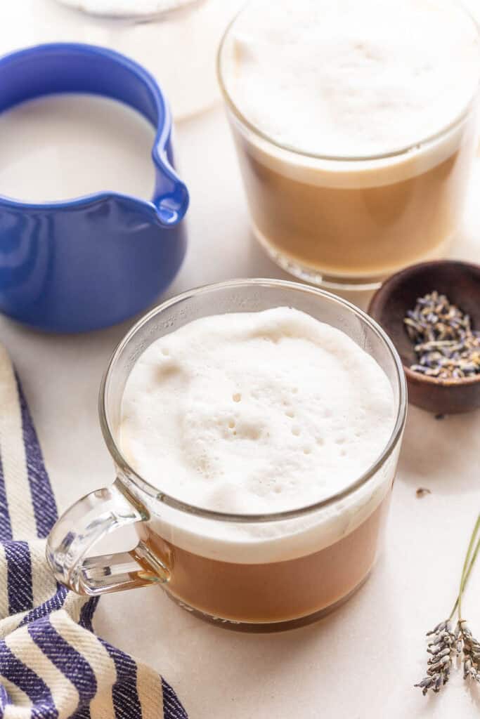 a couple mugs of homemade London fog with milk and lavender on the side