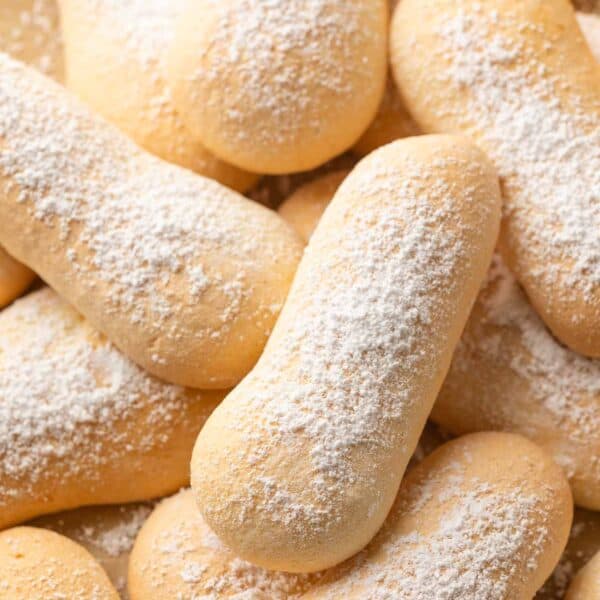 gluten free ladyfingers in a pile with powdered sugar on top