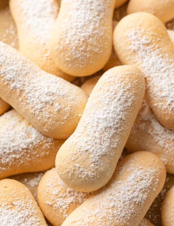 gluten free ladyfingers in a pile with powdered sugar on top