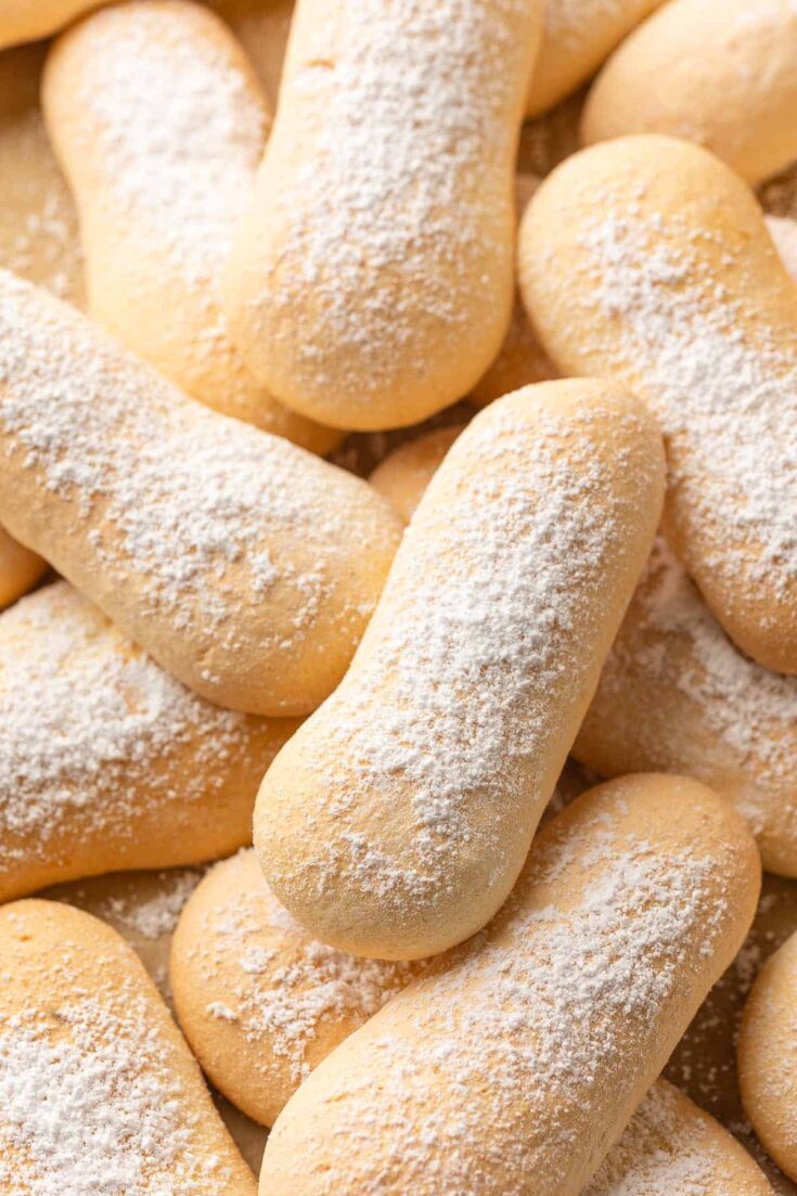 gluten free ladyfingers in a pile with powdered sugar on top