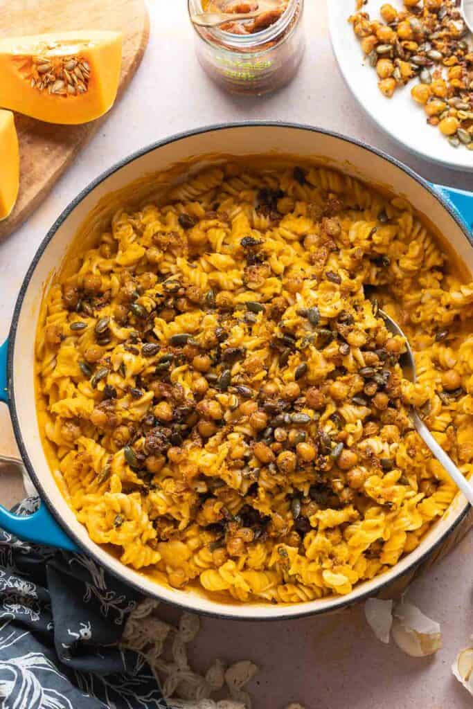 A pan full of Creamy Roasted Butternut Squash Pasta made with gluten free fusilli and fried chickpeas and pumpkin seeds mixed into the pasta.