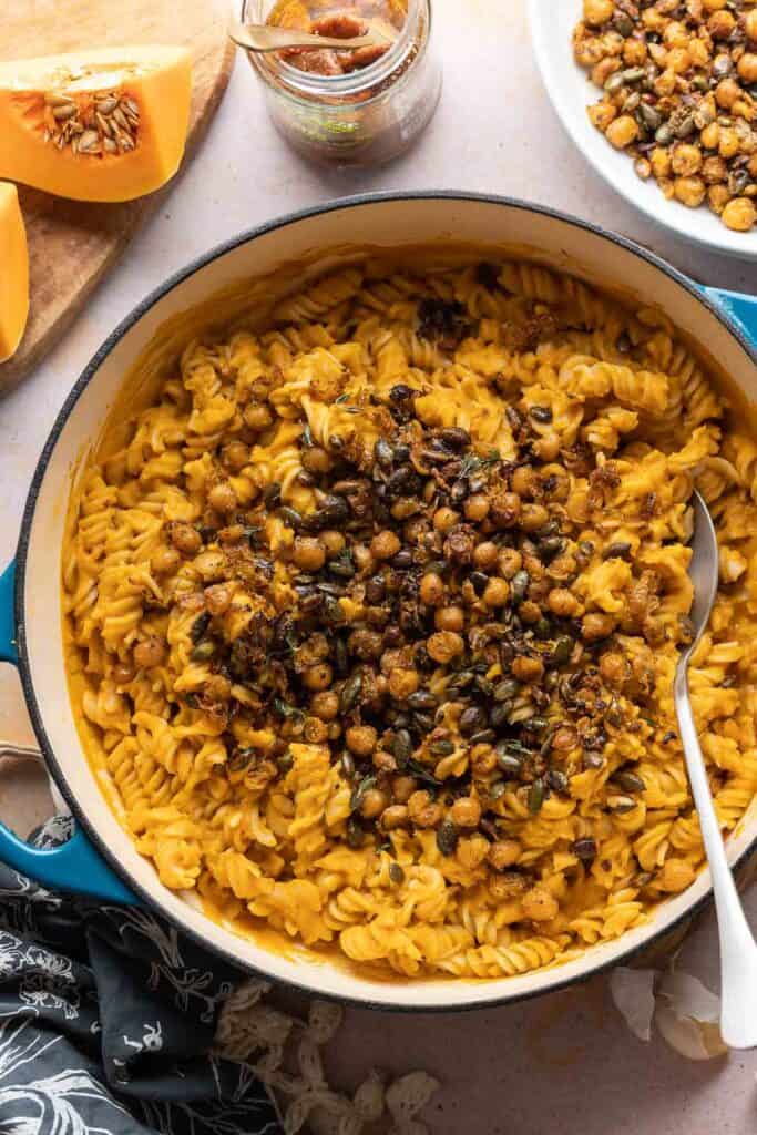 A pan full of Creamy Roasted Butternut Squash Pasta  made with gluten free fusilli and topped with fried chickpeas and pumpkin seeds. 