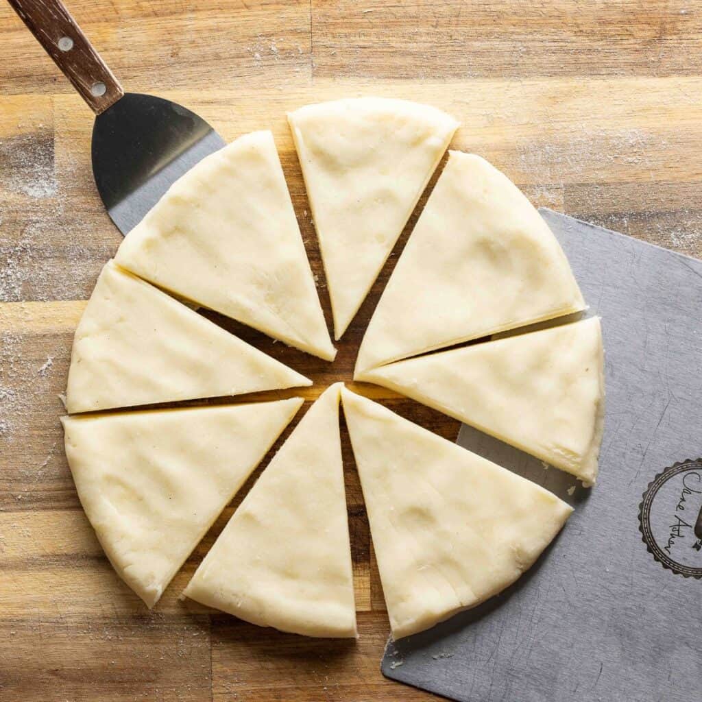 Irish Potato Bread dough formed in a round disc (about 8 inches wide) and cut into 8 equal sized wedges. 