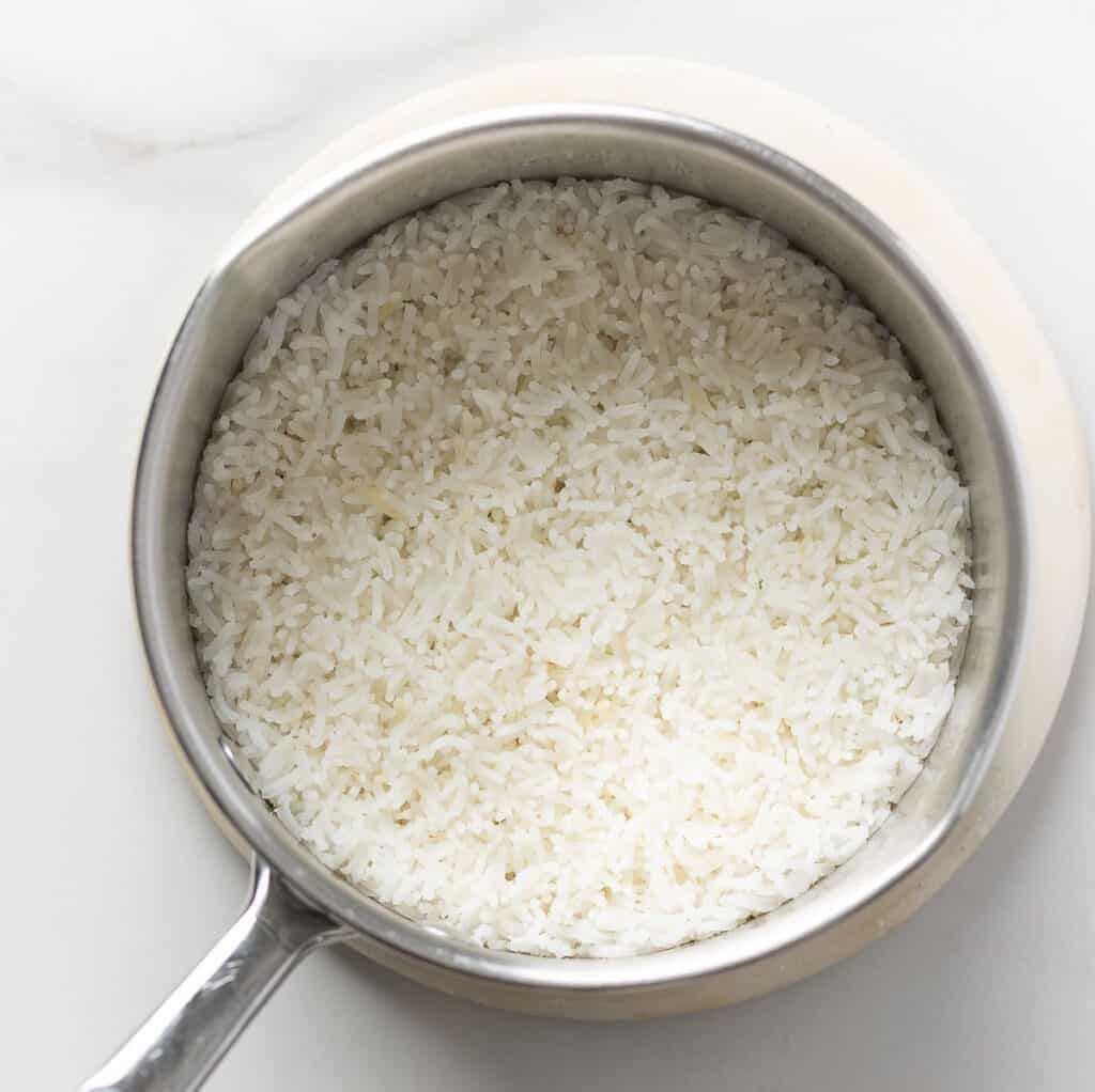 A small pot full of cooked rice.